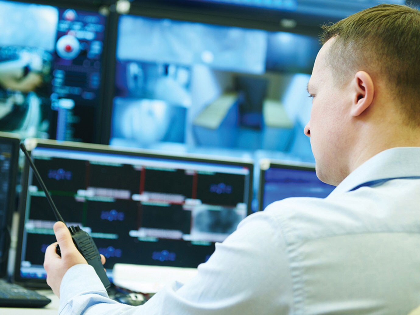 man monitoring video surveillance footage