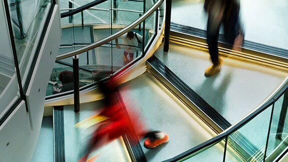 people walking along spiral staircase