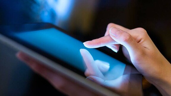 Close up of a person using a tablet