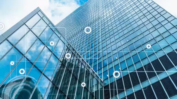 Low-angle view of a high-rise building, overlaid with a modern graphic