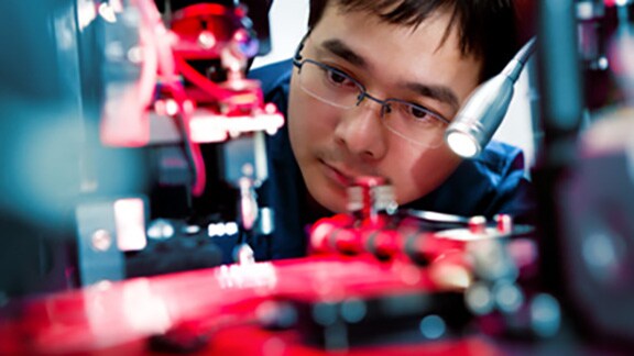 A mechanic examining the interior of a device