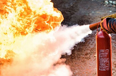 firefighter putting fire white extinguisher
