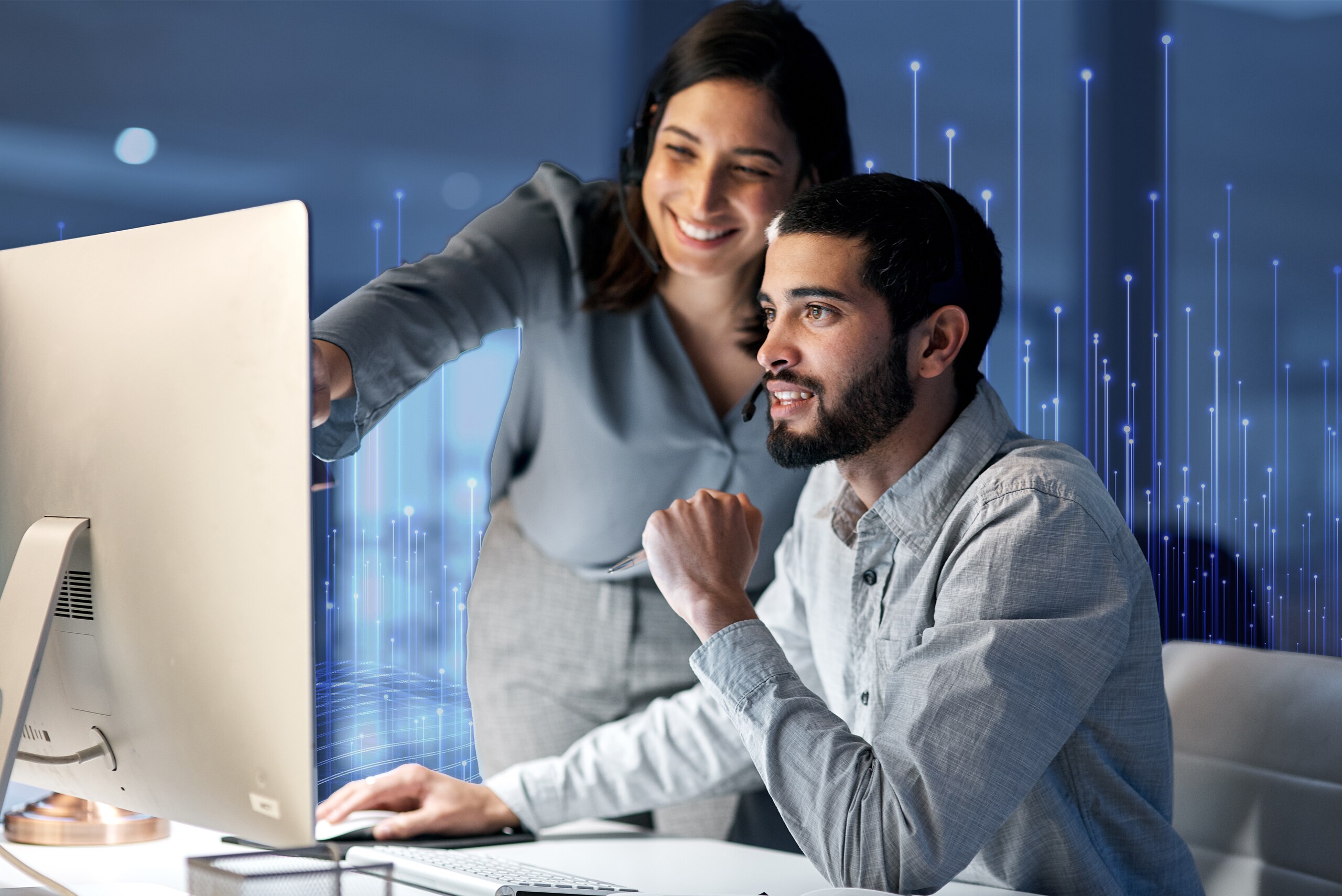 A man & women looking into monitor