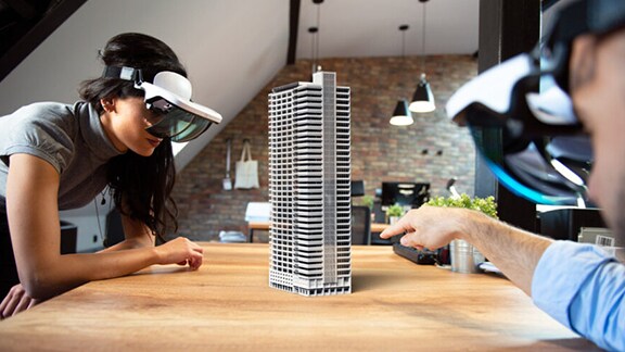 Two people exploring building view with the help of VR