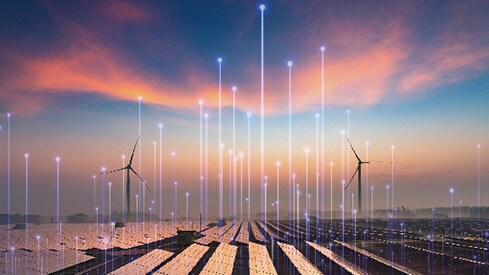 A wind turbine farm at sunset, overlaid with OpenBlue graphics