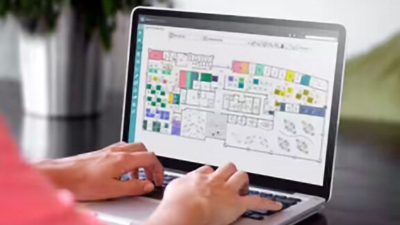 Close-up of a person working on a laptop