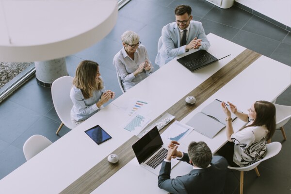 People sitting across a conference table having a discussion