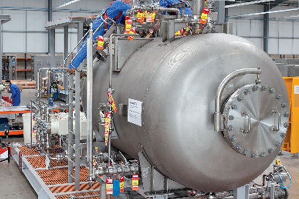 People in safety gear working in a factory