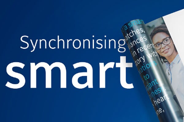 Two magazines with one half-rolled and text that reads 'Synchronizing Smart, Download Now'