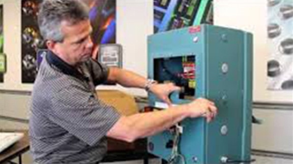 A person opening machinery parts.